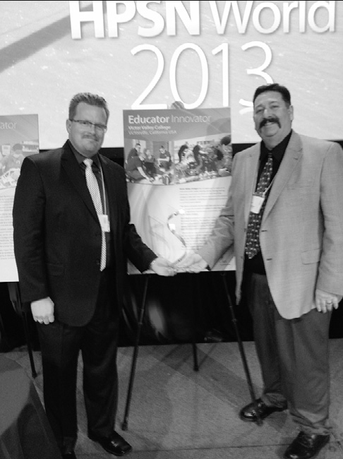 Dave Oleson and Brian Hendrickson hold award received at 201